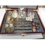 A jewellery box containing various medals and badges.