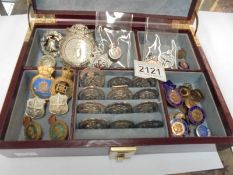 A jewellery box containing various medals and badges.