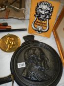 A cast iron Duke of Wellington plaque, a brass Caesar and a book on cast iron by Michael Owen.