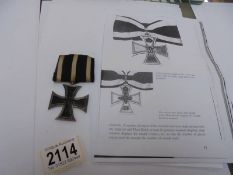 An Iron cross medal dated 1914.