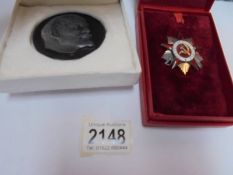 A Russian badge and a Russian medallion.