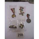 A Portsmouth Navy week medal, a European war souvenir medal, a Victorian medal and yellow flowers