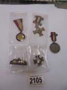 A Portsmouth Navy week medal, a European war souvenir medal, a Victorian medal and yellow flowers