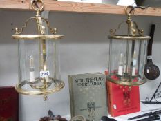 A pair of heavy brass hall lanterns with glass panels, Height 45 cm, diameter 23.5 cm.