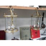 A pair of heavy brass hall lanterns with glass panels, Height 45 cm, diameter 23.5 cm.