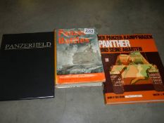 An autographed edition of Panzerheld by Gregory T Jones and two other tank related books.