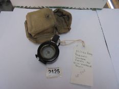 A British army prismatic compass dated 1941 with webbing pouch.