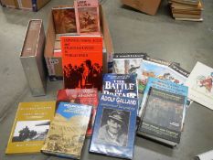A box of mixed books relating to war.