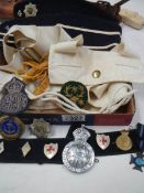 A mixed lot of badges, caps and other military items.