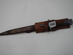 A Wilkinson bayonet in leather scabbard, blade 30.5cm.