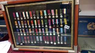 A framed and glazed display of Briish Campaign and Gallantry medals, frame size 65 x 50 cm. COLLECT