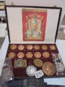 A case containing eleven Napoleon Empire coins together with other Napoleon related coins.