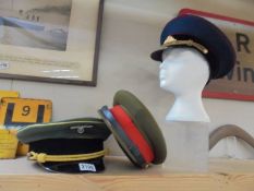 A German army generals visor cap size 61, A Russian soviet army peaked cap, size 57