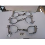 Three sets of hand cuffs with keys.
