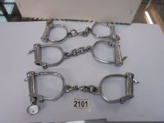 Three sets of hand cuffs with keys.