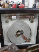 A glass cased fire hose from John Players. COLLECT ONLY.