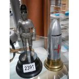 A lighter in the shape of a knight in armour and a money box in the shape of a 1914-18 bullet.