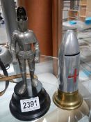 A lighter in the shape of a knight in armour and a money box in the shape of a 1914-18 bullet.