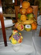 Two ceramic fruit ornaments.