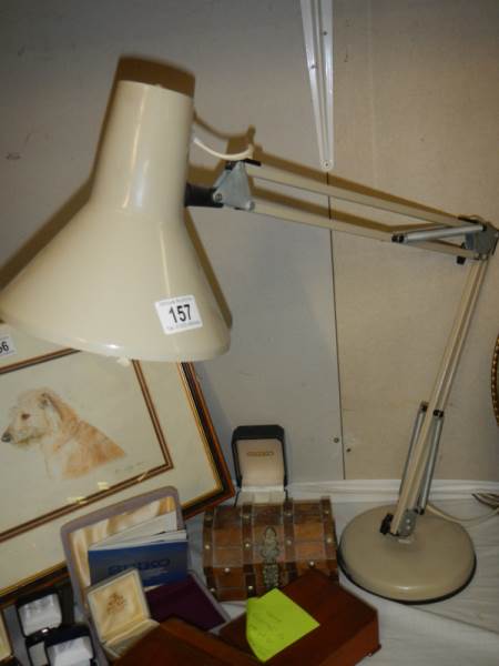 An angle poise desk lamp.
