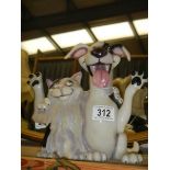 A novelty cat and dog figure.