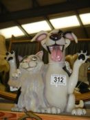 A novelty cat and dog figure.