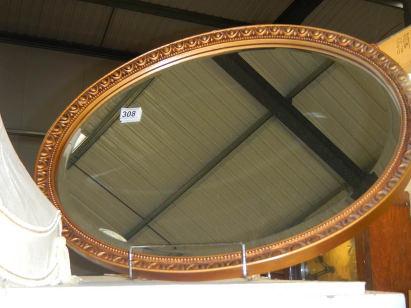 An oval bevel edged mirror, COLLECT ONLY.