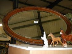 An oak framed oval bevel edged mirror, COLLECT ONLY.