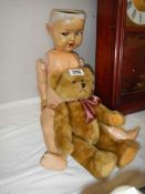 A vintage doll a/f and a teddy bear.