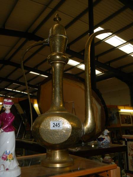 An oriental brass coffee pot.