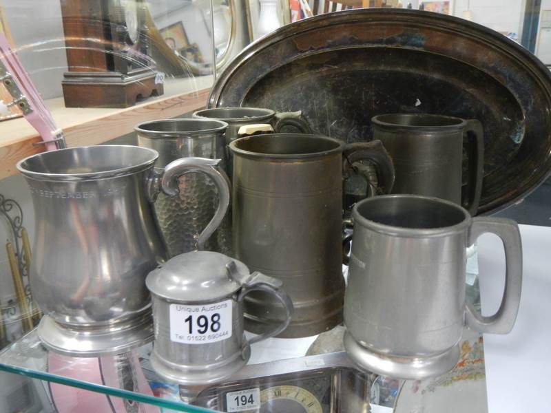A mixed lot of pewter tankards and other metal ware.
