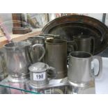A mixed lot of pewter tankards and other metal ware.