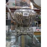 A silver plate spirit kettle on stand.