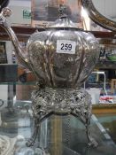 A silver plate spirit kettle on stand.