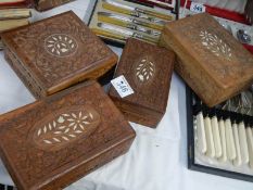 Four carved and inlaid boxes.