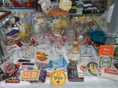 A mixed lot of pub glasses and beer mats,. COLLECT ONLY.