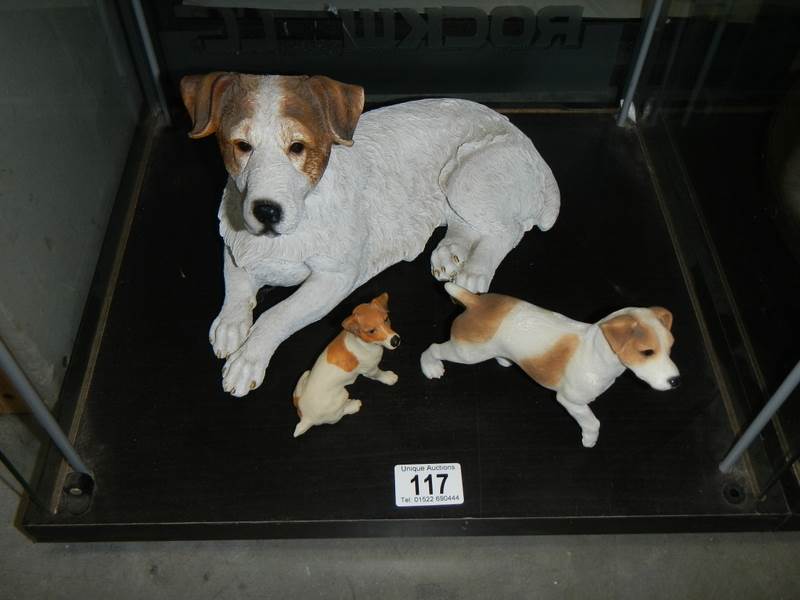 A large Terrier and two other dogs.