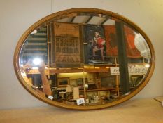 An oval bevel edged mirror, COLLECT ONLY.