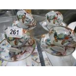 Four Japanese porcelain tea cups and saucers.