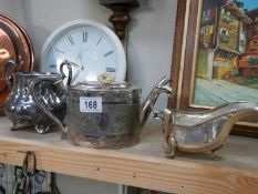 A silver plate teapot, sugar bowl and gravy boat.