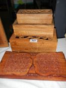 Three wooden boxes and a wooden book rack.