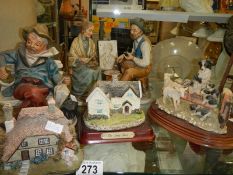 Two cottages, a sheepdog with sheep and two other figures.