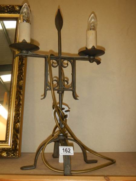 A Wrought iron lamp.