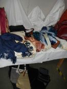 A mixed lot of scarves and hand bags.