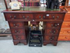 A dark stained double pedestal desk with gilded green leather top COLLECT ONLY