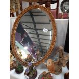 An oval bevel edged mirror, COLLECT ONLY.