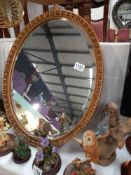 An oval bevel edged mirror, COLLECT ONLY.