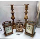 A pair of Victorian brass candlesticks & a Finnigans Paris carriage clock (overwound) & 2 others