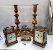 A pair of Victorian brass candlesticks & a Finnigans Paris carriage clock (overwound) & 2 others