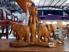 A vintage African carved wooden table lamp of 2 elephants by a tree, approximate height 33cm,